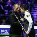 Northern Ireland's Mark Allen (left) shakes hands with Ding Junhui on the opening day of the MrQ UK Championship 2023 at York Barbican. (Photo by Richard Sellers/PA Wire)