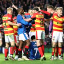 Rangers' Malik Tillman pushed over by Partick Thistle players after scoring his side's second goal during the Scottish Cup fifth round match at Ibrox