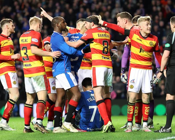 Rangers' Malik Tillman pushed over by Partick Thistle players after scoring his side's second goal during the Scottish Cup fifth round match at Ibrox