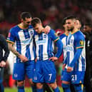 Brighton and Hove Albion's Lewis Dunk comforts Solly March after missing a penalty in the shoot-out following the Emirates FA Cup semi final match at Wembley Stadium, London.
