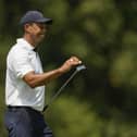 Tiger Woods reacts to his putt on the 10th hole during the first round of the Masters golf tournament at Augusta National Golf Club.
