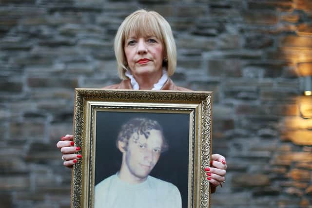 Karen Armstrong holds a photograph of her brother John McConville who was killed in the Kingsmill attack by the IRA in 1976.