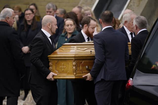 The coffin of James O'Flaherty is carried into St Mary's Church, Derrybeg for his funeral mass.