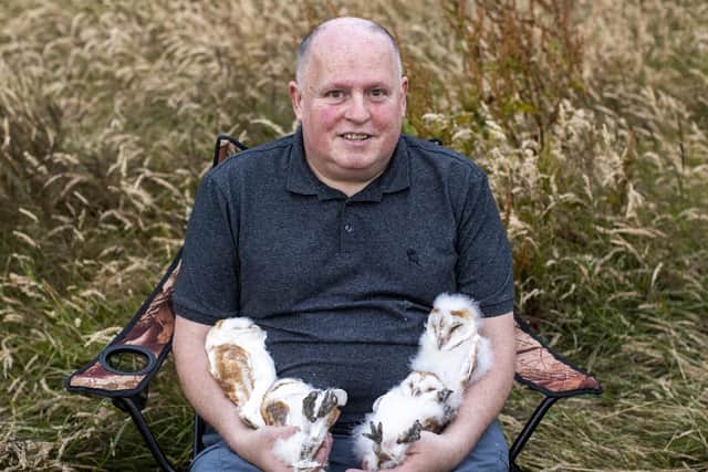 Volunteer nest minder Ciaran Walsh, holding four owlets after they have been ringed close to the shores of Lough Neagh in Crumlin, Co. Antrim. Photo: Liam McBurney/PA Wire