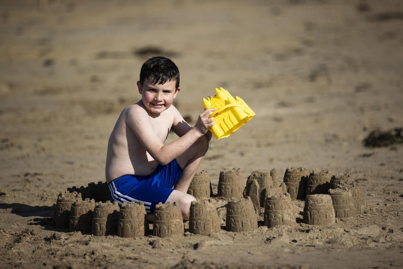 Carter Morrison, eight, from Lisburn, building sandcastles at Helen's Bay in Bangor, Northern Ireland.