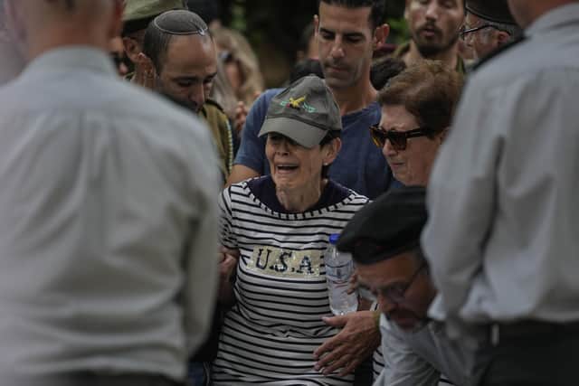 The mother of Israeli Col. Roi Levy cries during her son's funeral at the Mount Herzl cemetery in Jerusalem on Monday. Col. Roi Levy was killed after Hamas terrorists stormed from the blockaded Gaza Strip into nearby Israeli towns