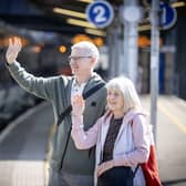 William Watson and Kay McCarthy wave farewell to a departing train at Great Victoria Street Station yesterday morning