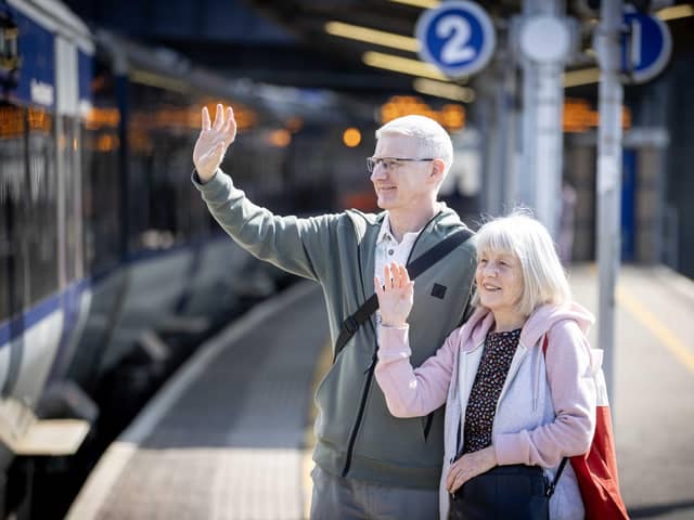 William Watson and Kay McCarthy wave farewell to a departing train at Great Victoria Street Station yesterday morning