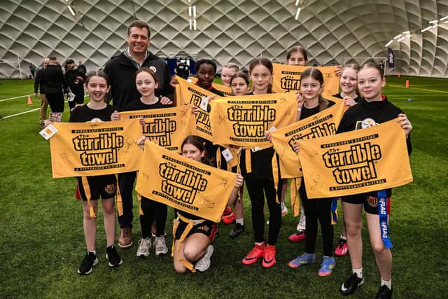 Dan Rooney, Steelers Vice President of Business Development and Strategy, poses with local children during an event at the Colin Glen Leisure Centre in Belfast, Northern Ireland, ahead of the first-ever NFL game in Ireland between the Minnesota Vikings and Pittsburgh Steelers at Croke Park, Dublin, on Sunday