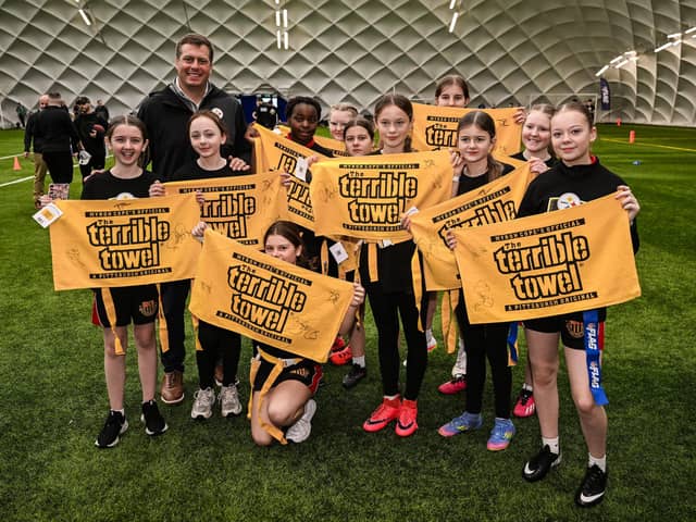 Dan Rooney, Steelers Vice President of Business Development and Strategy, poses with local children during an event at the Colin Glen Leisure Centre in Belfast, Northern Ireland, ahead of the first-ever NFL game in Ireland between the Minnesota Vikings and Pittsburgh Steelers at Croke Park, Dublin, on Sunday