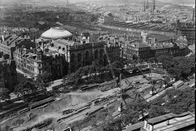 This aerial picture over Castle Terrace and Kings Stable Road, taken in 1962, shows a multi storey car-park under construction with the sheds of Princes Street Station in the distance.