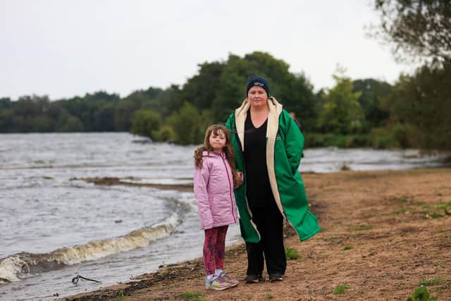 Mary O'Hagan with her daughter Katie on the shore of Ballyronan beach as environmental campaigners have held a "wake" at Ballyronan beach for Lough Neagh lake amid claims toxic algae is killing the UK and Ireland's largest freshwater lake. Photo: Liam McBurney/PA Wire