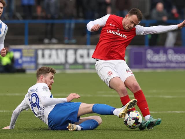 Coleraine striker Jamie McGonigle closes down Larne midfielder Chris Gallagher during Saturday's contest at The Showgrounds