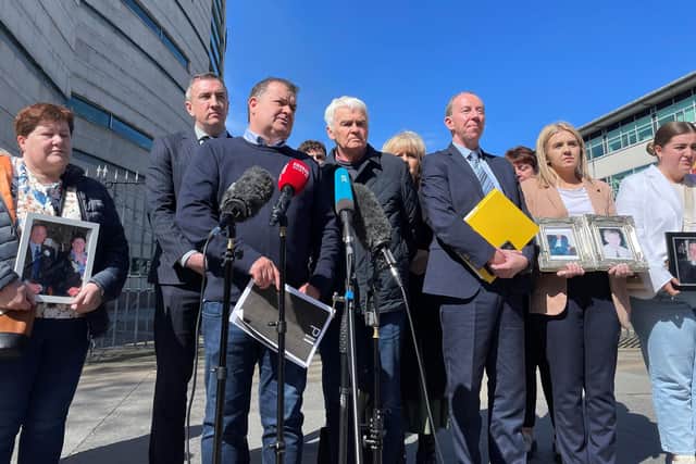 Paddy Fox (left), son of murdered Charles and Tess Fox, and Tommy McKearney (second left), brother of murdered Kevin McKearney, speak to the media outside Belfast Coroners Court