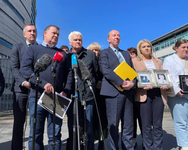 Paddy Fox (left), son of murdered Charles and Tess Fox, and Tommy McKearney (second left), brother of murdered Kevin McKearney, speak to the media outside Belfast Coroners Court
