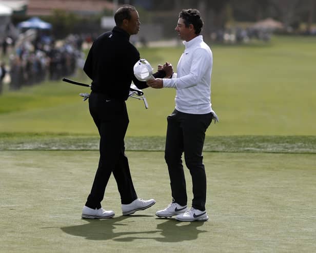 Northern Ireland's Rory McIlroy (right) shakes hands with Tiger Woods on the ninth green during the second round of The Genesis Invitational at Riviera Country Club