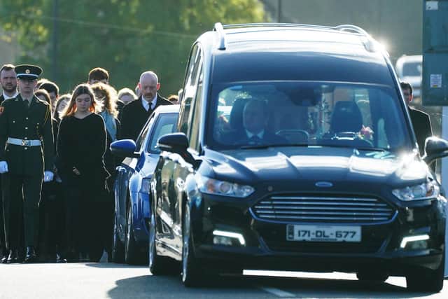 Family and mourners walk behind the hearse carrying the coffin of of 49-year-old mother of four Martina Martin, who died following an explosion at the Applegreen service station in the village of Creeslough in Co Donegal on Friday, on their way to St Michael's Church, in Creeslough, for her funeral mass.