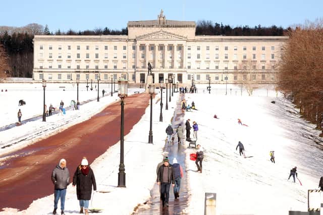 People enjoy the snow at Stormont in east Belfast.