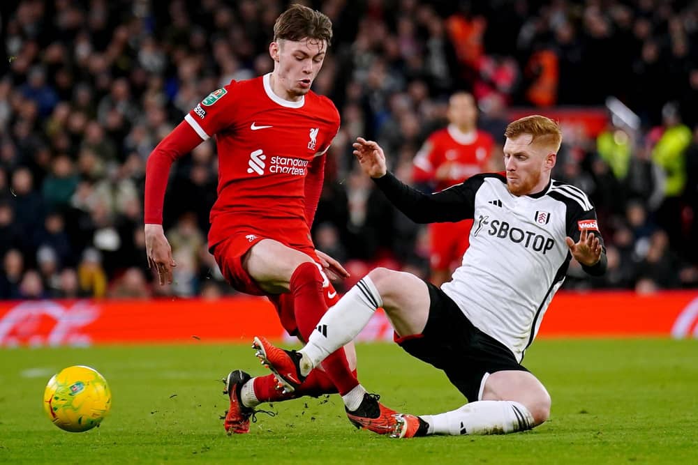 Liverpool's Conor Bradley (left) and Fulham's Harrison Reed battle for the ball during the Carabao Cup semi final first leg match at Anfield, Liverpool. PIC: Peter Byrne/PA Wire.