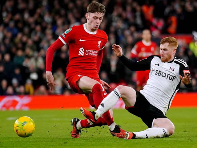 Liverpool's Conor Bradley (left) and Fulham's Harrison Reed battle for the ball during the Carabao Cup semi final first leg match at Anfield, Liverpool. PIC: Peter Byrne/PA Wire.