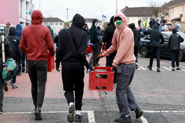 A group of young men carrying crates of petrol bombs at the start of an Easter Monday parade in the Creggan area of Londonderry