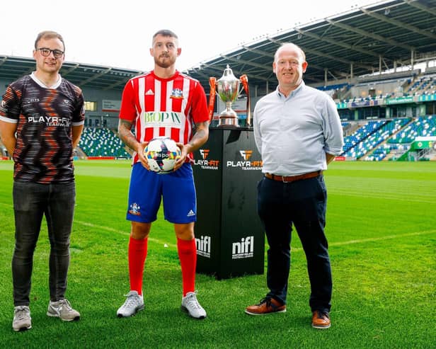 Ballymacash Rangers striker Jack Smith pictured at Windsor Park alongside Kieran Quinn and Darren McPolin from Playr-Fit. PIC: NIFL
