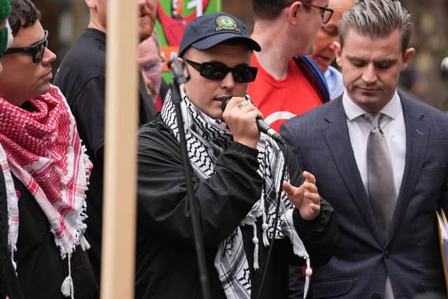 Kneecap's Liam Og O hAnnaidh, speaks to supporters as he leaves Westminster Magistrates' Court, London, where he was charged with a terrorism offence. The 27-year-old, of Belfast, who performs under the stage name Mo Chara, has been charged with a terrorism offence relating to displaying a flag in support of Hezbollah at a gig at the O2 Forum in Kentish Town, London, on November 21 last year. He faces a month-long wait to find out whether his terrorism charge will be thrown out. Picture: Lucy North/PA Wire