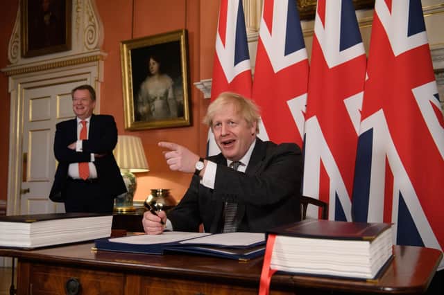 The then UK chief trade negotiator, David Frost looks on as Prime Minister Boris Johnson signs the EU-UK Trade deal at 10 Downing Street, on December 30, 2020. How stupid they were to think the damaging effects of the Irish Sea border would see to its own demise. Ceding NI was far more likely. Photo: Leon Neal/PA Wire