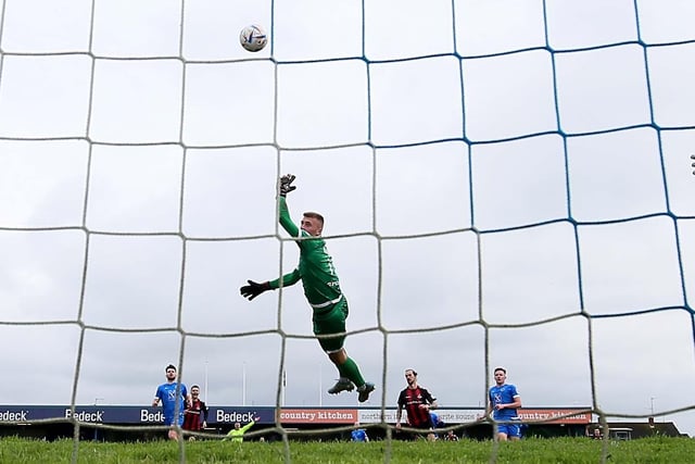 Dungannon's Declan Dunne is left stranded as Crusaders Declan Caddell lobs the keeper to book their spot in the final