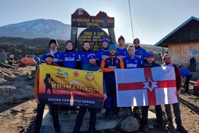 Some of the Hiking For Little Heroes group cheering on Rangers in their Old Firm clash from Mount Kilimanjaro