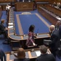 Alliance MLAs walk out of the chamber during a confidence debate in their farming minister Andrew Muir.