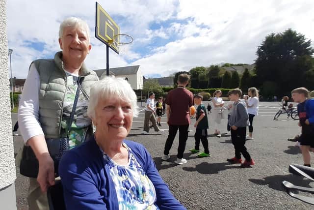 Gladys Blackstock, left, and Ruth Cochrane enjoying watching children play at the coronation Bank Holiday Carnvial in Dromore. Ruth recalls watching the coronation of Queen Elizabeth the second but says she was very busy at the time and was able to take much more in this time.