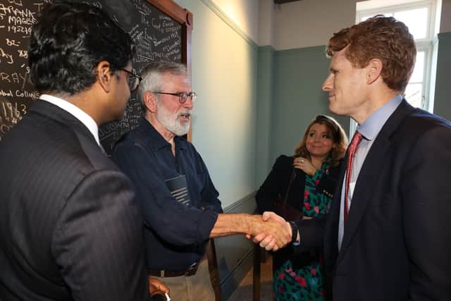 US Special Envoy to Northern Ireland for Economic Affairs, Joseph Kennedy III (right), shakes hands with former Sinn Fein leader Gerry Adams (centre), watched by Paul Narain, US Consul General Belfast, at the reopening of St Comgall's School on the Falls Road in Belfast. Photo: Liam McBurney/PA Wire