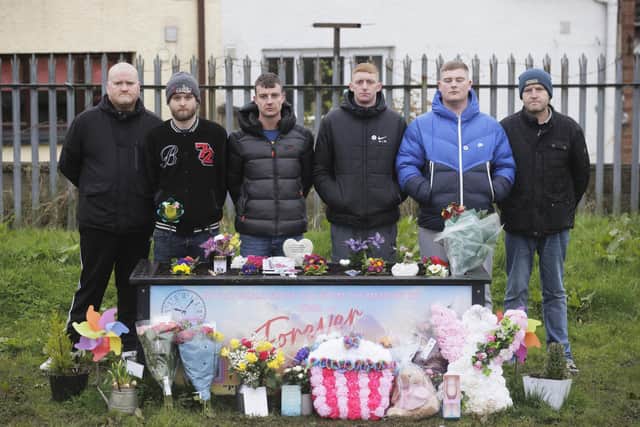 Philip Mitchell (third left), the brother of Chloe Mitchell, with family members during a memorial event for his sister at King George's Park, Ballymena