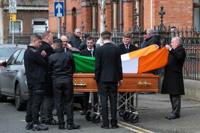 Family and friends gather for the funeral of Gerard 'Hucker' Moyna in west Belfast as his coffin makes it way to St. Paul's for Requiem Mass