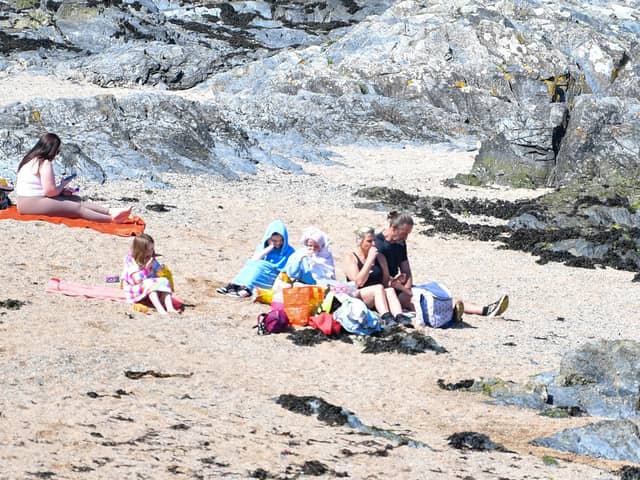 Families enjoy the sun on the beach at Bangor on Sunday 19 May 2024, as the good weather continues. Photo - Andrew McCarroll/ Pacemaker Press
