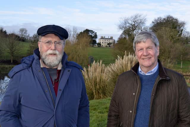 Estate owner Michael Lagan (left) and Joe Mahon with the big house of the Florida Manor restoration project behind them