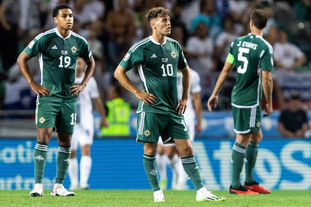 Northern Ireland's Shea Charles, Dion Charles and Jonny Evans look dejected during the Euro 2024 qualifier against Slovenia in Ljubljana last night