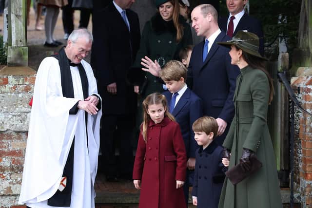 The Reverend Canon Dr Paul Williams (L) talks to (centre, L-R) Princess Charlotte of Wales, Prince George of Wales, Prince William, Prince of Wales, Prince Louis of Wales and Catherine, Princess of Wales, after the Christmas Day service at Sandringham Church on December 25, 2022. (Photo by Stephen Pond/Getty Images)