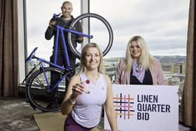 Free health checks, yoga, physiotherapy sessions, first aid training and more on offer as part of Linen Quarter Health Week 2022. Pictured are Tim Edgar Manager of Big Loop Bikes, yoga teacher Nichola Suitor and Charlotte Irvine, finance and contracts manager at LQ BID