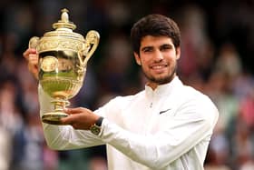 Carlos Alcaraz of Spain with the men's singles trophy following his victory against Novak Djokovic at Wimbledon. (Photo by Julian Finney/Getty Images)