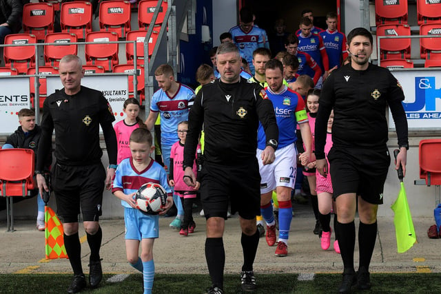 Referee Raymond Crangle leads the Institute and Linfield teams on the pitch for Sunday’s  IFA Cup encounter at Brandywell stadium. Photo: George Sweeney