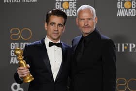 Colin Farrell, winner of the award for best performance by an actor in a motion picture, musical or comedy for "The Banshees of Inisherin," left, and Martin McDonagh, winner of the award for best screenplay, motion picture for "The Banshees of Inisherin," pose in the press room at the 80th annual Golden Globe Awards at the Beverly Hilton Hotel on Tuesday, Jan. 10, 2023, in Beverly Hills, Calif. (Photo by Chris Pizzello/Invision/AP)