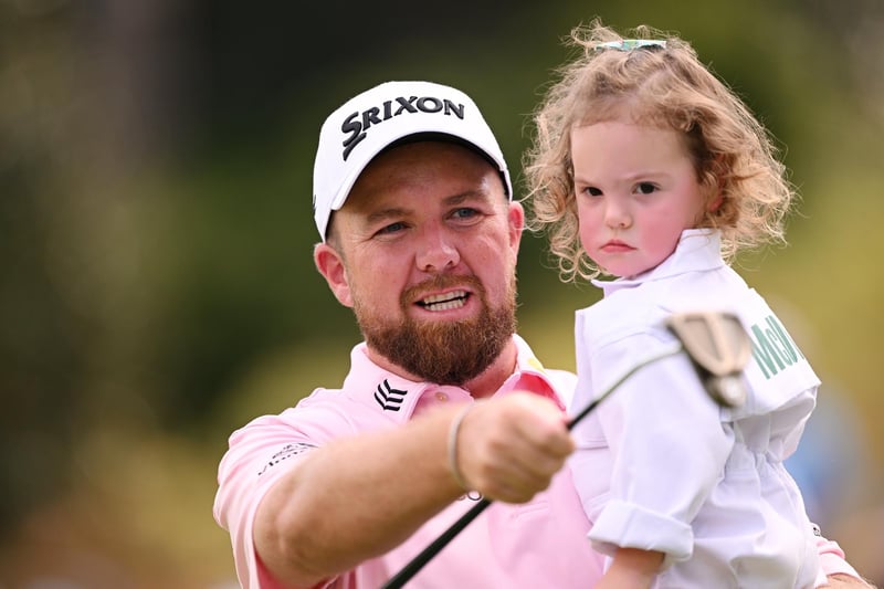 Shane Lowry of Ireland looks  on with Rory McIlroy of Northern Ireland daughter Poppy McIlroy on the first hole during the Par 3 contest prior to the 2023 Masters Tournament at Augusta National Golf Club on April 05, 2023 in Augusta, Georgia. (Photo by Ross Kinnaird/Getty Images)