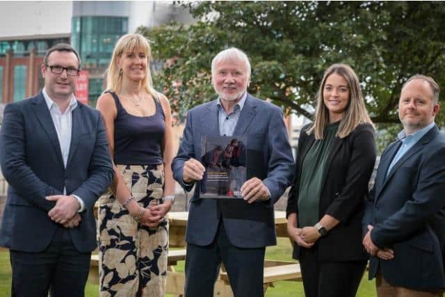 Announcing the emissions reduction at Belfast Harbour are Nicolas Cowan, head of sustainability, Jenni Barkley, community engagement manager, Sir Malcolm McKibbin, chair of Belfast Harbour ESG Committee, Stephanie Buchanan, senior people business partner and Eoghan Rainey, compliance manager