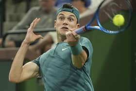 Jack Draper, of Britain, returns a shot to Andy Murray, of Britain, at the BNP Paribas Open tennis tournament.