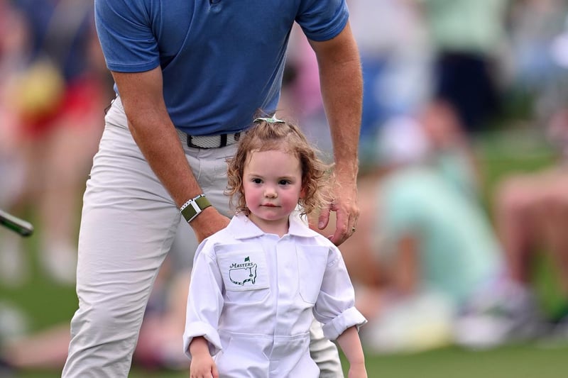 AUGUSTA, GEORGIA - APRIL 05: Rory McIlroy of Northern Ireland  looks on with his daughter Poppy McIlroy on the first hole during the Par 3 contest prior to the 2023 Masters Tournament at Augusta National Golf Club on April 05, 2023 in Augusta, Georgia. (Photo by Ross Kinnaird/Getty Images)