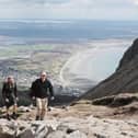 L-R National Trust Mountain rangers Theo Burke and James Fisher walk along the newly constructed 2 kilometers of hand laid stone path on Slieve Donard in Newcastle Co Down. Picture date: Friday May 21, 2021.