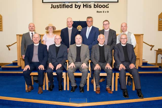 Those who took part in the Sending Forth Service in Dungannon Free Presbyterian Church for the Carscadden family. Back Row Standing (L to R) Mr Jonathan McAuley, Miss Tirzah Walker, Rev James Porter, Mr Alastair Hamilton, Rev Raymond Robinson, Mr David Moore. Front Row Seated (L to R) Revs David McMillan, Colin Mercer (Mission Board Chairman), Ray Carscadden, John Armstrong (Moderator of Presbytery), and Gordon Dane.
