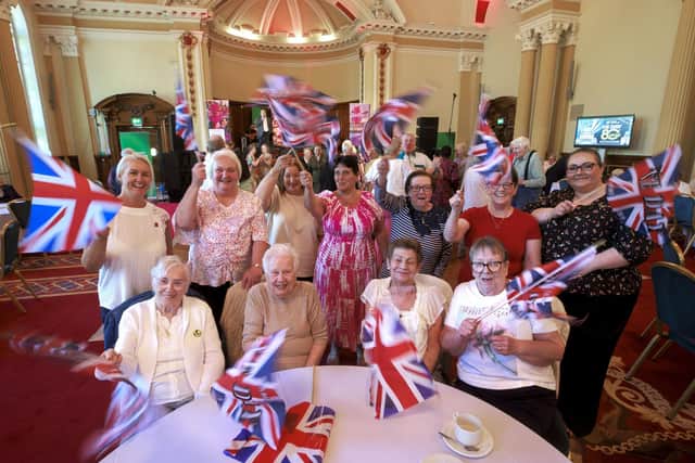Women enjoy themselves at a tea party in Belfast City Hall, and King Charles III leaves yesterday’s Westminster Abbey service Pics: Liam McBurney and Aaron Chown/PA Wire